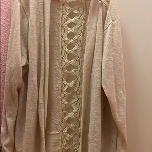 Beige cardigan with design in back.